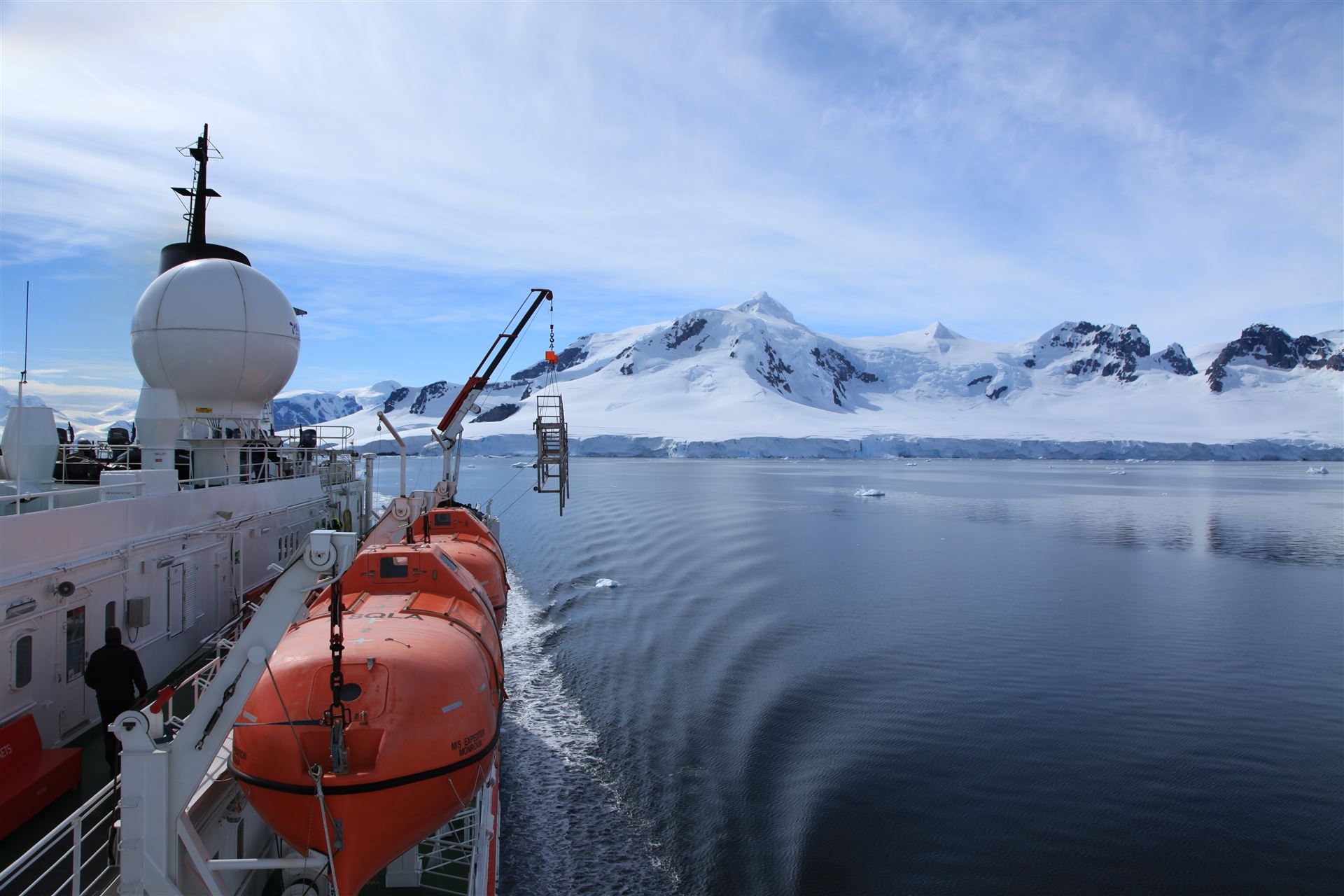 Expedition ship navigating past snow-covered mountains in the Gerlache Strait, Antarctica